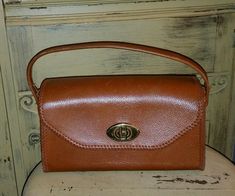 THIS IS A BEAUTIFUL VINTAGE 50'S ERA LEATHER HANDBAG ,BROWN WITH BROWN WHIP STITCHING,BRASS TURN LATCH CLOSURE.CLOTH  LINED.MEASURES 6" TALL X 10" LONG AND 4" DEEP.NO MARKINGS,NO LEATHER WEAR,A VERY COOL UNIQUE HANDBAG.SMOKE FREE HOME.SEE MORE GREAT VINTAGE BAGS IN MY STORE! SHIPPING IN US 12.65 CANADA 25.00 OVERSEAS PRIORITY INSURED 65.00 Vintage Brown Shoulder Bag Satchel, Vintage Brown Satchel Bag, Vintage Crossbody Satchel With Detachable Handle, Mid-century Brown Shoulder Bag For Everyday Use, Vintage Evening Crossbody Satchel, Retro Brown Vintage Bags, Brown Mid-century Shoulder Bag For Everyday Use, Mid-century Brown Satchel Bag, Mid-century Brown Shoulder Bag