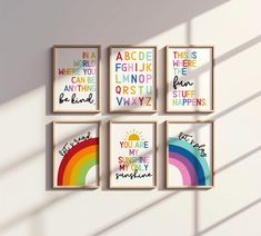 four framed posters on the wall in different colors and sizes, each with their own sayings