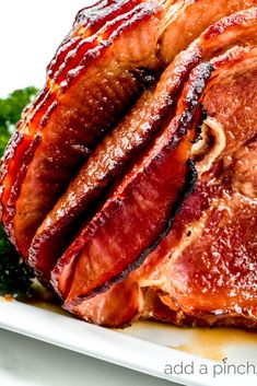 a close up of meat on a plate with broccoli