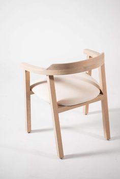 a wooden chair sitting on top of a white floor