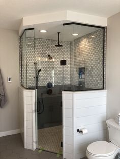 a bathroom with a toilet, shower and sink in it's center area is shown