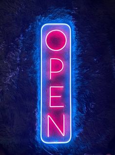 a neon sign that says open on it