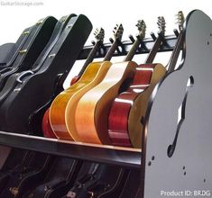 guitars are lined up in a rack on display