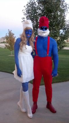 two people in costumes standing on a sidewalk