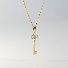 A golden vintage key pendant, oh so bright, with cubic zirconia that shines like light.  This 14K gold Key Pendant is designed to resemble a vintage key, with intricate details and a polished finish. The key's bow is adorned with sparkling cubic zirconia stones that add a touch of glamor to the overall look. Unique and elegant, this handcrafted jewelry will turn heads and leave a lasting impression. Fine jewelry such as this luxury pendant is a staple of fashion accessories and makes a great gif Luxury Gold Jewelry With Keys, Gold Key Pendant Jewelry, Gold Pendant Jewelry With Keys, Yellow Gold Key Pendant Jewelry, Tiffany Key Necklace, Sacred Spiral, Gold Key Necklace, Tiffany Key, Spiral Necklace