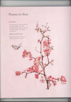 an open book with flowers and a bird on the cover, in front of a white background