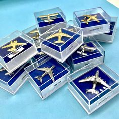 a bunch of airplanes that are sitting in some glass cases on a table with blue and white background