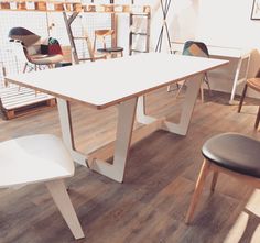 a table and chairs in a room with hard wood flooring