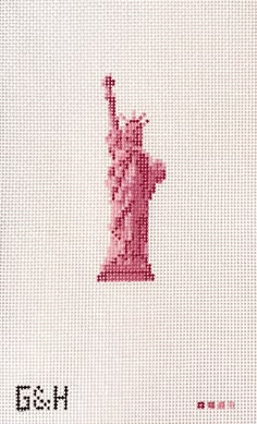 the statue of liberty cross stitched on to a white fabric with red lettering that reads, i love new york