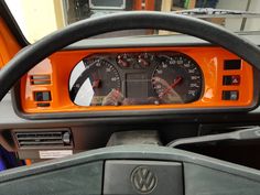 the dashboard of a vehicle with an orange dash