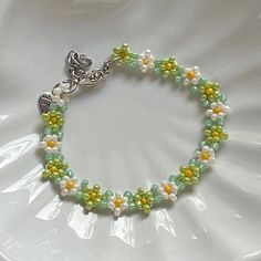 "Handmade Beaded Bracelet 🍵 ✿ Made with glass seed beads and metal accents ✿ Matcha green, milky white, yellow, and sea foam green ✿ The bracelet has 1.5\" of extension chain" Green Beaded Chain Bracelet For Gift, Green Beaded Bracelet For Gift, Green Beaded Chain Bracelets As A Gift, Green Beaded Chain Bracelet As Gift, Green Beaded Chain Bracelets For Jewelry Making, Green Beaded Chain Bracelet For Jewelry Making, Green Beaded Bracelet With Spacer Beads For Friendship, Green Beaded Bracelets With Round Beads, Handmade Green Flower Beaded Bracelets