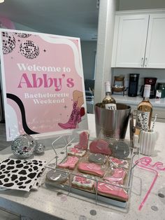 there is a sign and some cookies on the kitchen counter with it's name