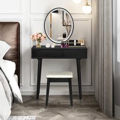 a bedroom with a vanity and mirror on the wall, along with a stool in front of it