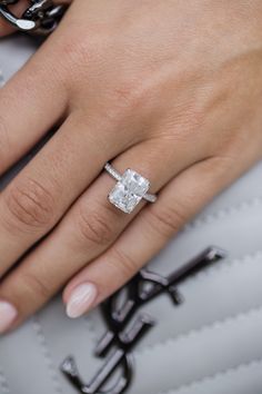 a woman's hand with a diamond ring on it