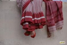 there is a towel hanging from the side of a wall next to a woman's feet