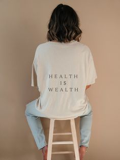 "This \"health I$ wealth\" inspirational quote aesthetic t-shirt is the perfect wellness gift for yourself or a loved one. This is a minimal typography unisex tee. The \"s\" in \"is\" has been replaced with a US dollar symbol. This is the perfect workout tee. ON THE AVENUE LIFESTYLE was established in 2023 by myself Rachel, a UK-based mum who designs all the lifestyle pieces at my home in Lancashire to help create the best life for my two young girls. They're perfect for those who like minimal, clean designs with meaning. The shirt is unisex for that perfect, comfy, oversized aesthetic. You may want to size up for a looser fit. Made from heavy cotton for that extra luxe. No side seams for extra comfort. .: 100% cotton (fibre content may vary for different colours) .: Medium fabric (5.3 oz/ Wellness Lifestyle Aesthetic, Healthy Life Style Aesthetic, Wealth Aesthetic, Dollar Symbol, Oversized Aesthetic, Minimal Typography, Health Gifts, Health Is Wealth, Perfect Workout