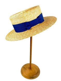 Straw boater hat made with 8/9 millimeters natural straw braid. Embellished with a 50 millimeters wide blue grosgrain ribbon. You can choose the grosgrain ribbon in the color you like best - (in this ad the grosgrain is azure)Measurements in centimeters are 34 x 32. Crown height 9. Brim length 7. These measurements may have some slight variation depending on the size of the hat.For its elaboration we only use very good quality and resistant straw braids. In our workshop in the Pyrenees we sew an Twenties Style, Straw Boater Hat, Straw Boater, Boater Hat, Purple Ribbon, Summer Hat, Pyrenees, Blue Ribbon, Summer Hats