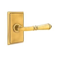 a brass door handle on a white background