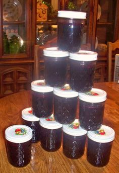 there are many jars on the table that have jam in them