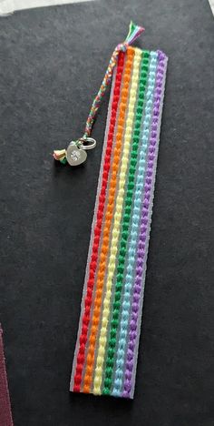 a multicolored crochet bookmark with a keychain attached to it