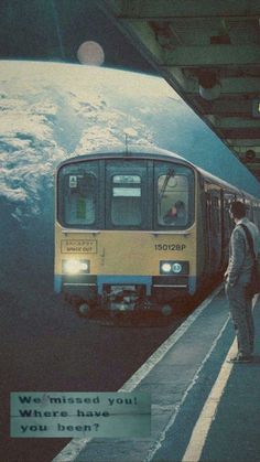 a man standing next to a train at a station with the words we missed you where have you been?