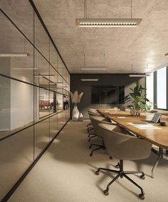 an empty conference room with wooden tables and chairs