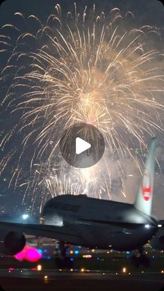 an airplane with fireworks in the background