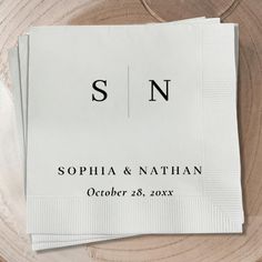 two napkins on top of each other with the letter sn printed on them