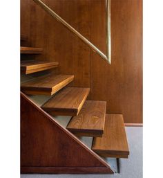 a wooden staircase with metal handrails in a house