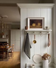 a kitchen with white walls and wooden floors