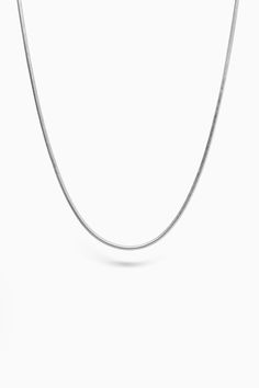 Discover the allure of the "Dusk Chain" - a striking snake chain silver necklace by Merchants of the Sun. Handcrafted with care from 925 recycled sterling silver, this minimalist accessory exudes timeless elegance. Designed for both men and women, the "Dusk Chain" adds a touch of sophistication to any ensemble. Elevate your style with the sleek and versatile "Dusk Chain" from Merchants of the Sun. Whether worn alone or layered with other necklaces, this unisex piece is a perfect gift for those seeking a touch of refined simplicity. Embrace the allure of the snake chain and make a bold statement with this stunning silver necklace. Crafted in daylight and cast into the night, our 925 sold-silver chains have been brought to life straight from a dream. As rich and complex as the twilight sky, Minimalist Link Necklace With Sterling Silver Clasp, Minimalist Sterling Silver White Gold Chain Necklace, Minimalist Sterling Silver Chain Necklace In White Gold, Minimalist White Gold Sterling Silver Chain Necklace, Silver Minimalist Box Chain Necklace, Minimalist White Gold Necklace With Sterling Silver Clasp, Silver Classic Snake Chain Necklace, Minimalist Tarnish Resistant Snake Chain Necklace, Classic Silver Snake Chain Necklace With Adjustable Chain