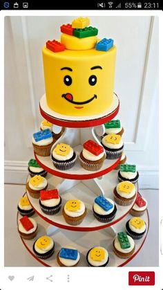 a three tiered cake with lego cupcakes on it