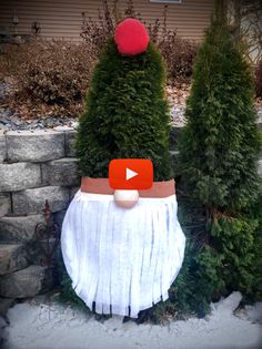 an image of a fake christmas tree with a red ball on it's head