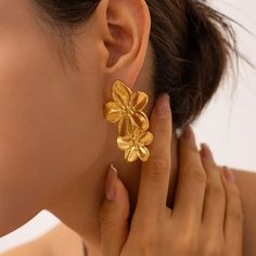 Channel your inner flower power with the Cherry Blossom Drop Earrings. The intricate design adds a touch of elegance to any outfit, making a statement wherever you go. Superbly crafted from 18k Gold-plated Stainless Steel, these earrings are lightweight and built to last. They're a perfect gift to yourself or your loved one who loves flowers. 18k Gold-Plated Stainless Steel Lightweight Hypoallergenic Skin-friendly and tarnish-resistant material Alloy Earrings, Silver Accessories, Stunning Earrings, Flower Studs, Floral Earrings, Stainless Steel Earrings, Party Looks, Stainless Steel Necklace, Gold Fashion