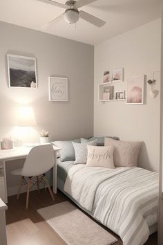 a small bedroom with a bed, desk and pictures on the wall above it's headboard