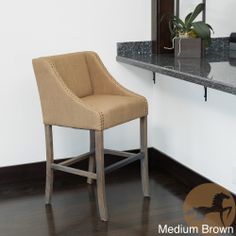 a chair sitting in front of a mirror next to a counter with a potted plant on it