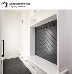 an entry way with white cabinets and black flooring