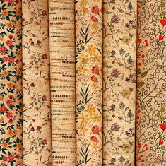 four different types of fabric with flowers and leaves on them, all lined up together