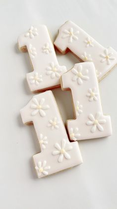 three decorated cookies are arranged in the shape of numbers one, two, and four