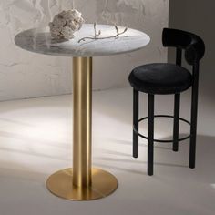 a marble table with two stools next to it