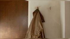 a coat hanging on the wall next to a door