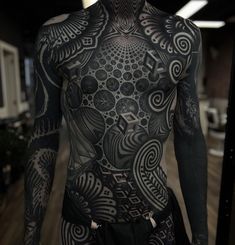 a man with tattoos on his body and chest