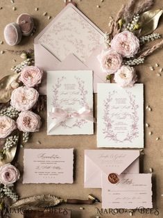 the wedding stationery is laid out and ready for guests