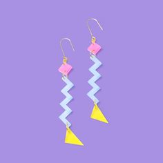 I just love this Zig Zag dangly earring. Memphis Design for your ears! Geometric and fun, this Zig zag retro earring hangs long but cuts a slim profile so they're not too loud. Just loud and funky enough to spice up any outfit.   * Hand-crafted with light weight acrylic in NYC.   * Measures 4.5" x 0.5" (115mm x 12mm)  * The pair weighs 4 grams total--that's less than two pennies!  * Uses nickel-free, gold-plated components to keep sensitive ears comfortable. 80s Colors, Dangly Earring, Too Loud, Hoop Charms, Memphis Design, Retro Earring, Pearl Collection, Colorful Jewelry, Dangly Earrings