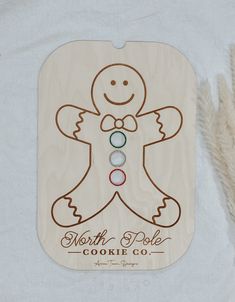 a wooden ornament with an image of a ginger on it and the words north pole cookie co