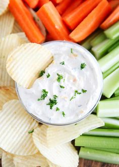 carrots, celery, and crackers are arranged on a cutting board