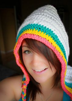 a woman wearing a crocheted hat and smiling