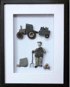 a shadow frame with an old man holding a wheelbarrow and some rocks in it