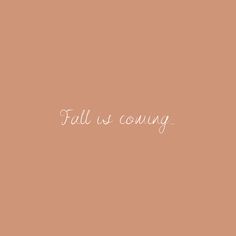 the words fall is coming written in white ink on a peach colored wallpaper background