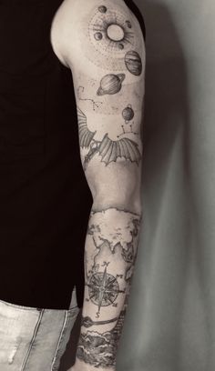 a man's arm with tattoos on it and other things in the sky behind him